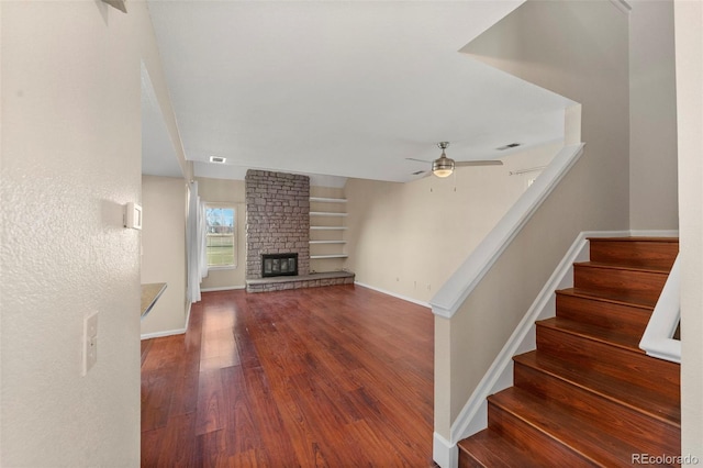 interior space featuring ceiling fan, a fireplace, and hardwood / wood-style floors