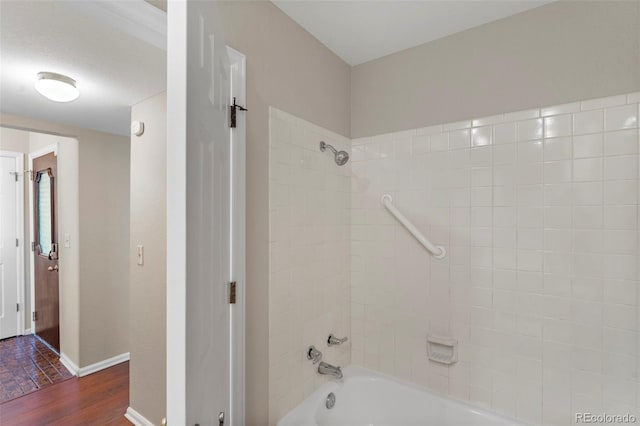 bathroom with tiled shower / bath combo and hardwood / wood-style flooring