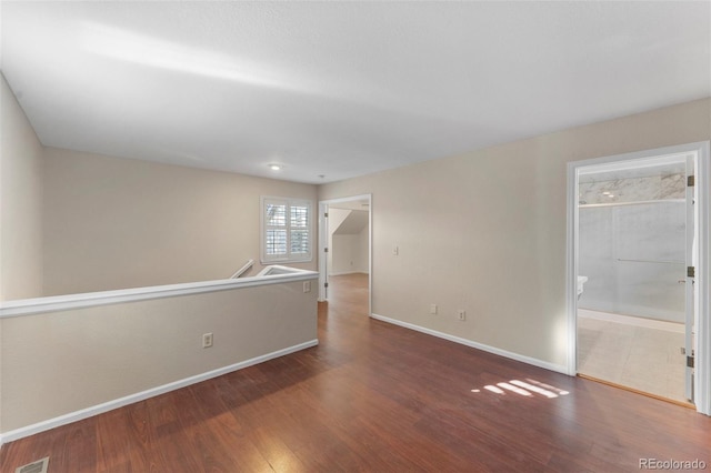 unfurnished room with wood-type flooring