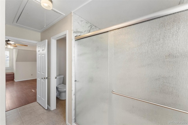 bathroom with tile patterned flooring, toilet, walk in shower, and ceiling fan