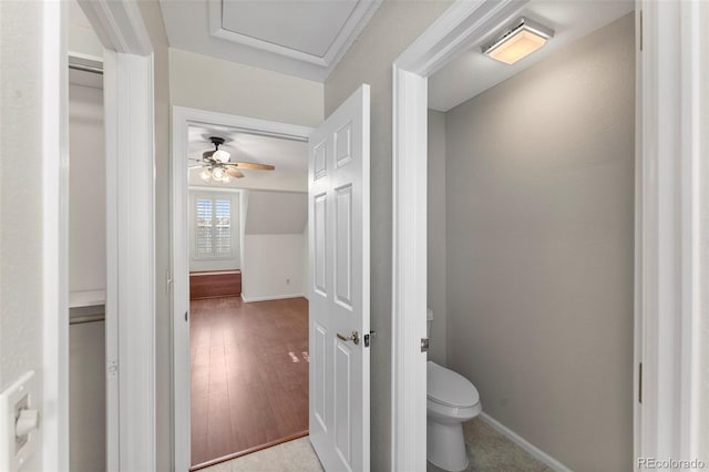 bathroom featuring toilet and ceiling fan