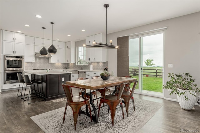 3168 Raintree Ln, Dacono, CO 80514 - dining area featuring dark wood-style floors and recessed lighting