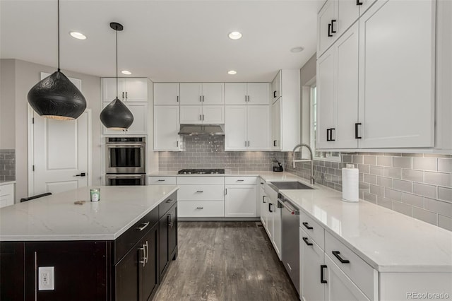 3168 Raintree Ln, Dacono, CO 80514 - kitchen featuring stainless steel appliances, white cabinets, dark wood-type flooring, tasteful backsplash, and under cabinet range hood