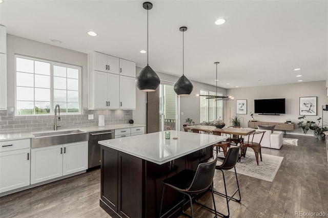3168 Raintree Ln, Dacono, CO 80514 - kitchen featuring stainless steel dishwasher, white cabinetry, decorative backsplash, dark wood-style flooring, and recessed lighting