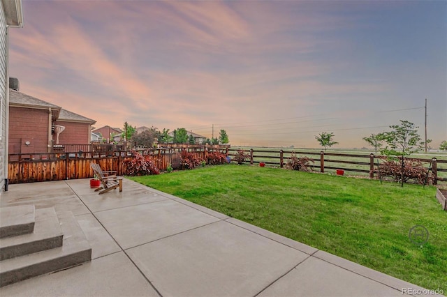 3168 Raintree Ln, Dacono, CO 80514 - yard at dusk with a patio area and a fenced backyard