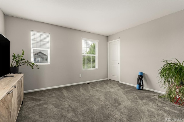 3168 Raintree Ln, Dacono, CO 80514 - spare room with dark carpet