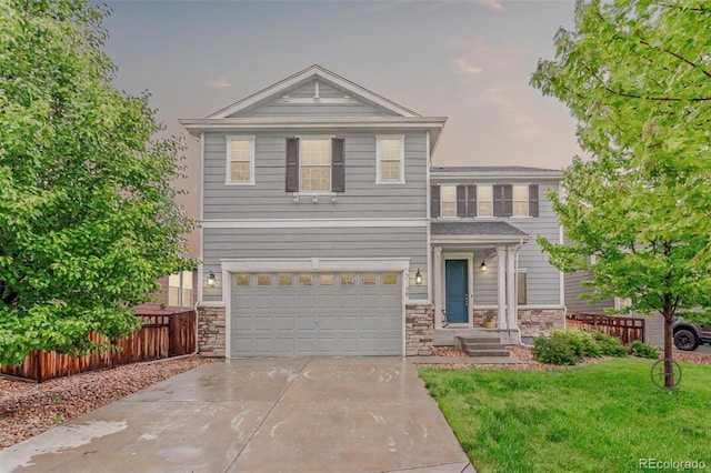 3168 Raintree Ln, Dacono, CO 80514 - view of front of property featuring stone siding, concrete driveway, and an attached garage