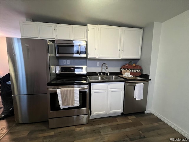 kitchen with sink, white cabinetry, dark hardwood / wood-style flooring, and stainless steel appliances