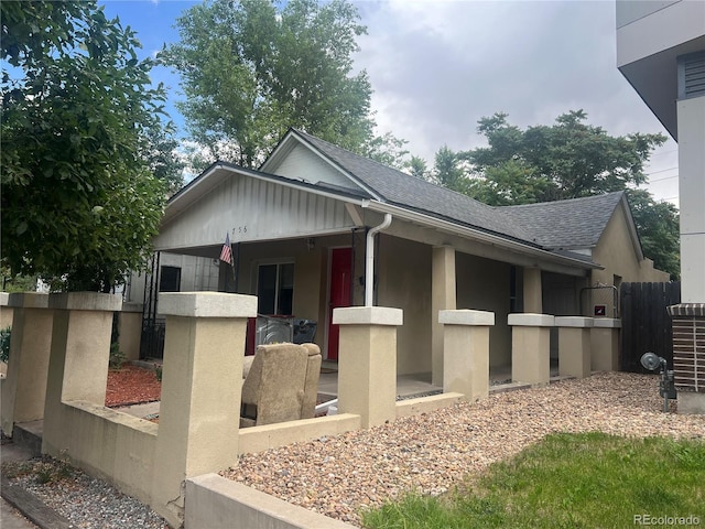 view of side of property featuring covered porch