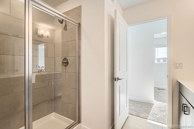 full bath with a shower stall and baseboards