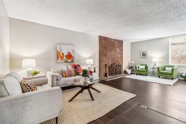 living room with a brick fireplace and a textured ceiling