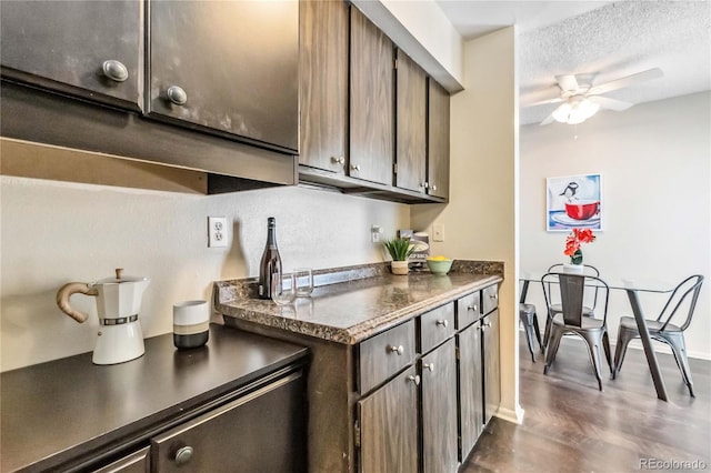 kitchen with ceiling fan, dark brown cabinets, and a textured ceiling