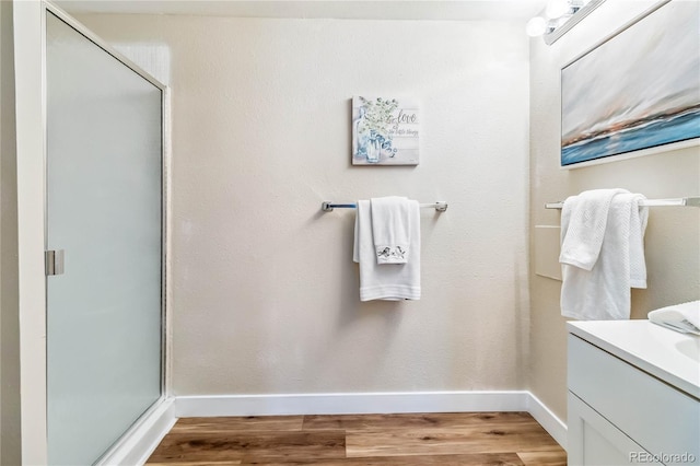 bathroom featuring vanity, a shower with door, and hardwood / wood-style floors