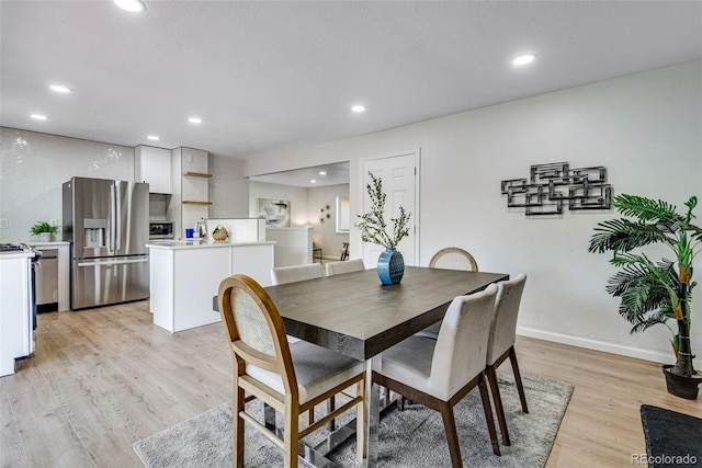 dining area featuring light wood-type flooring