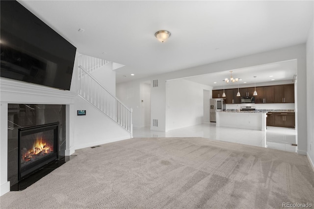 6387 Agave Ave, Castle Rock, CO 80108 - unfurnished living room with a chandelier, recessed lighting, light colored carpet, stairs, and a high end fireplace