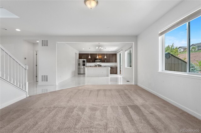 6387 Agave Ave, Castle Rock, CO 80108 - unfurnished living room featuring plenty of natural light, recessed lighting, a chandelier, stairway, and light carpet