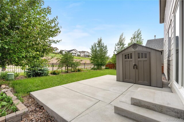 6387 Agave Ave, Castle Rock, CO 80108 - fenced backyard featuring a storage shed and a patio area