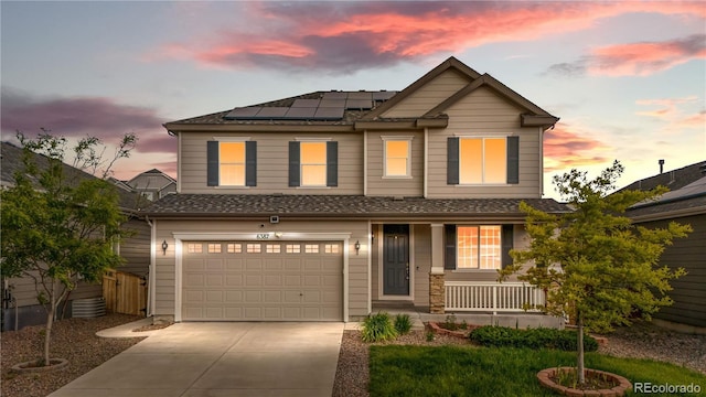 6387 Agave Ave, Castle Rock, CO 80108 - view of front of property featuring covered porch, driveway, a garage, and roof mounted solar panels
