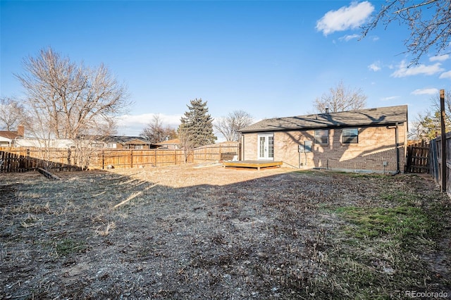 view of yard featuring a deck and french doors