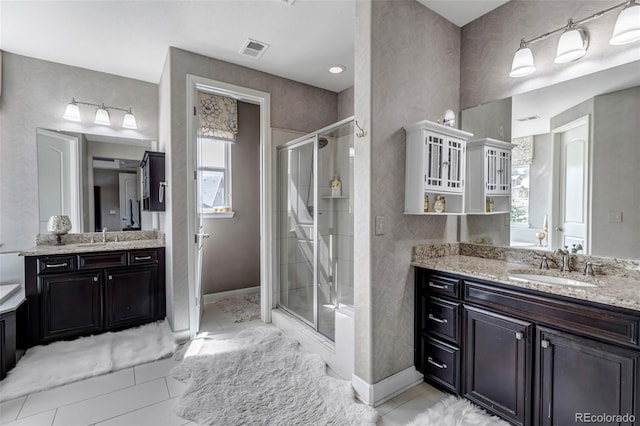 full bath with a shower stall, visible vents, baseboards, and a sink
