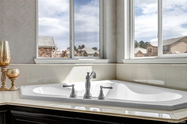 bathroom featuring a sink and wallpapered walls
