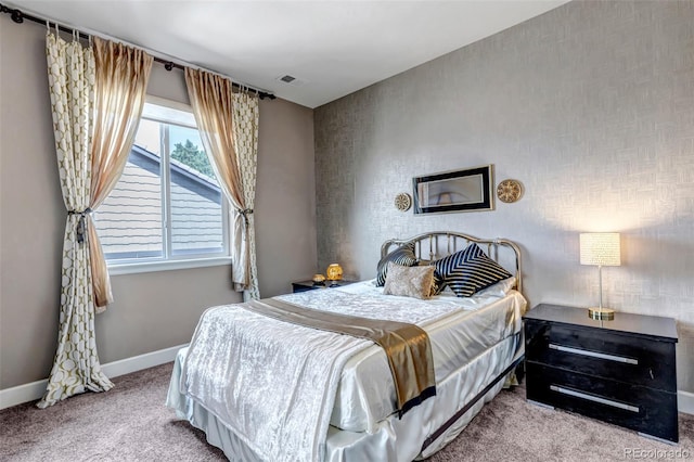 carpeted bedroom featuring visible vents and baseboards