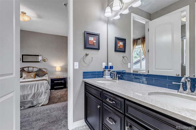 ensuite bathroom with tasteful backsplash, double vanity, ensuite bath, and a sink