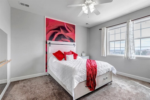 bedroom featuring visible vents, carpet flooring, baseboards, and a ceiling fan