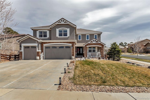 craftsman-style home featuring driveway, a porch, a garage, a front yard, and stucco siding