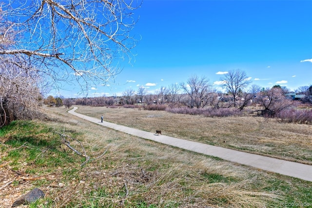 exterior space with a rural view and sidewalks