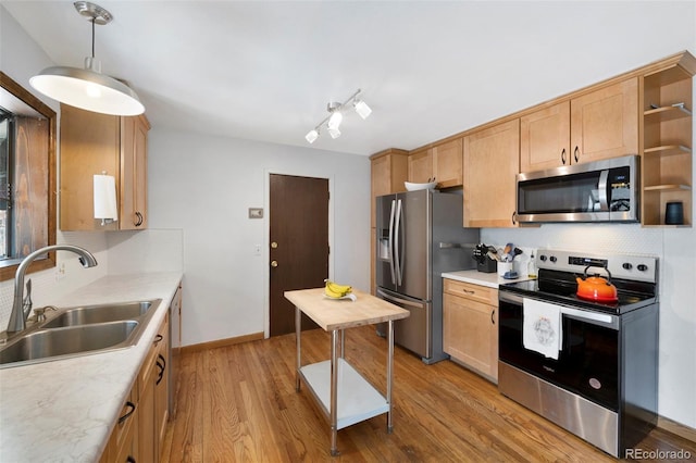 kitchen with open shelves, light countertops, appliances with stainless steel finishes, light brown cabinets, and a sink