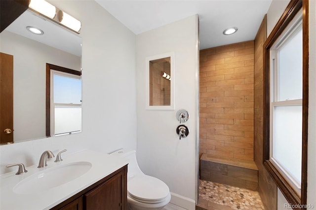 bathroom with toilet, recessed lighting, a walk in shower, and vanity