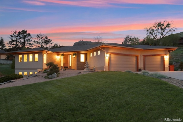 4305 Easley Rd, Golden, CO 80403 - view of front of property featuring a garage, stucco siding, driveway, and a front yard