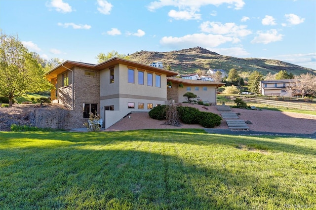 4305 Easley Rd, Golden, CO 80403 - back of house with a lawn, a mountain view, and stucco siding