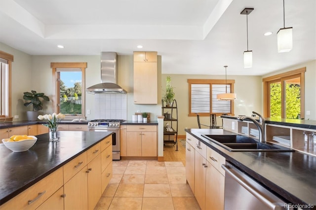 4305 Easley Rd, Golden, CO 80403 - kitchen with dark countertops, a sink, light brown cabinets, stainless steel appliances, and wall chimney exhaust hood