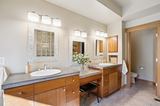 4305 Easley Rd, Golden, CO 80403 - bathroom featuring toilet, double vanity, tile patterned floors, and a sink