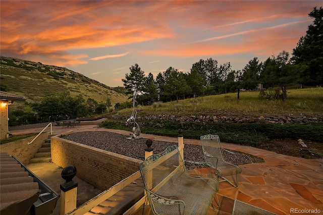 patio terrace at dusk with a mountain view