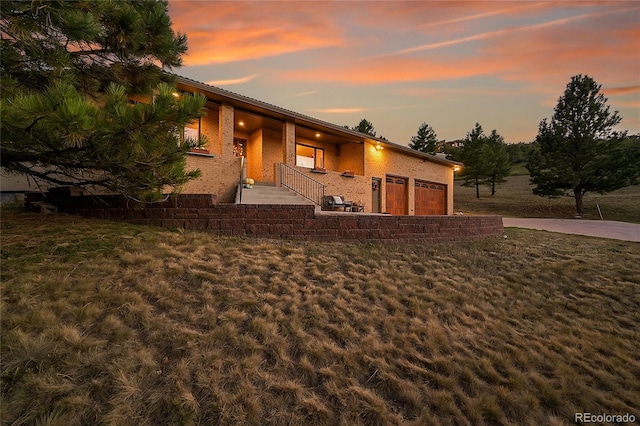 mid-century home featuring a lawn and brick siding