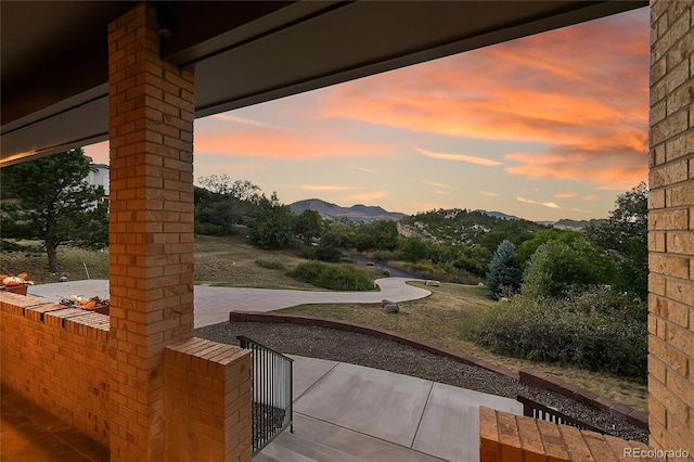 view of yard featuring a patio area and a mountain view