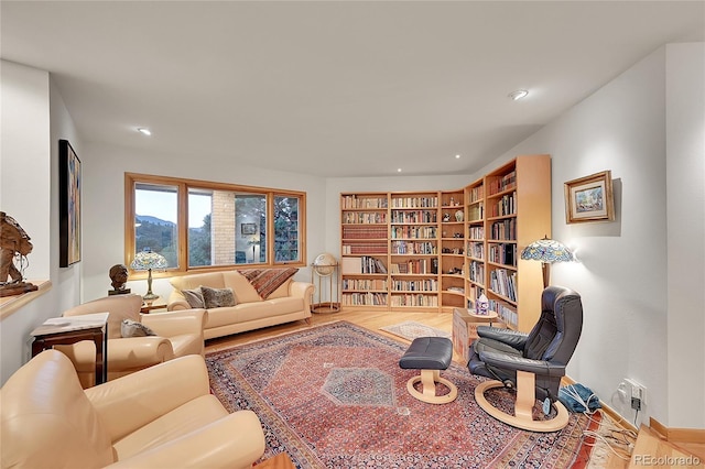 living room with baseboards, wood finished floors, and recessed lighting