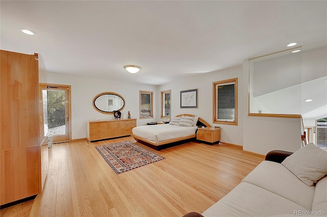 bedroom featuring light wood finished floors, baseboards, access to exterior, and recessed lighting