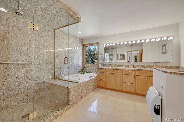 bathroom with double vanity, a sink, a shower stall, and a bath