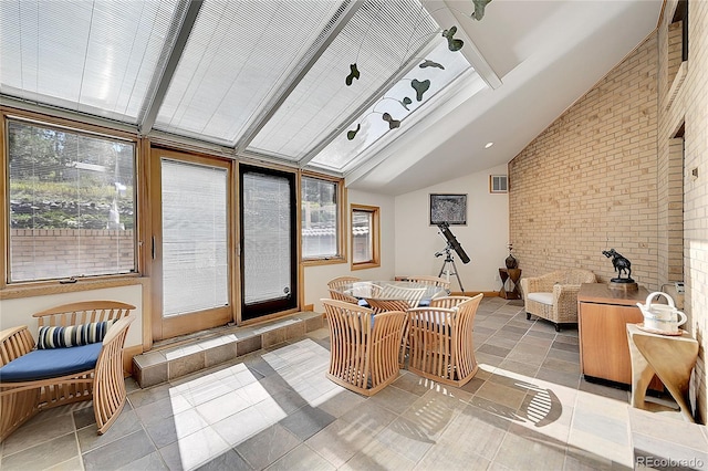 interior space featuring vaulted ceiling and a healthy amount of sunlight