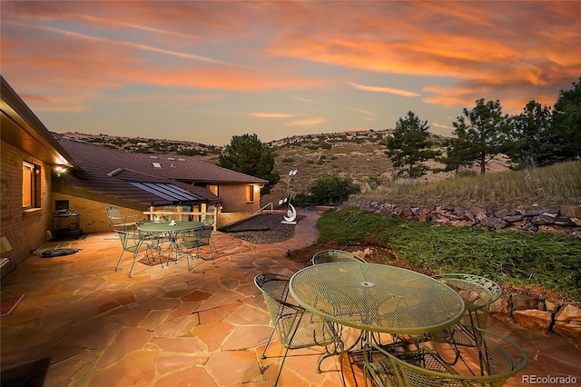 patio terrace at dusk with outdoor dining space