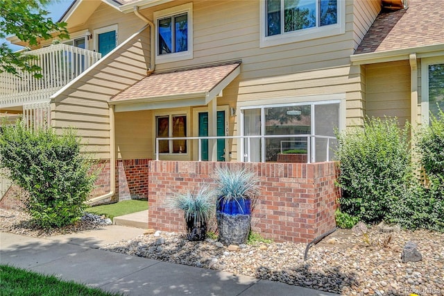 2181 S Troy Way Unit 103, Aurora, CO 80014 - property entrance featuring roof with shingles and brick siding
