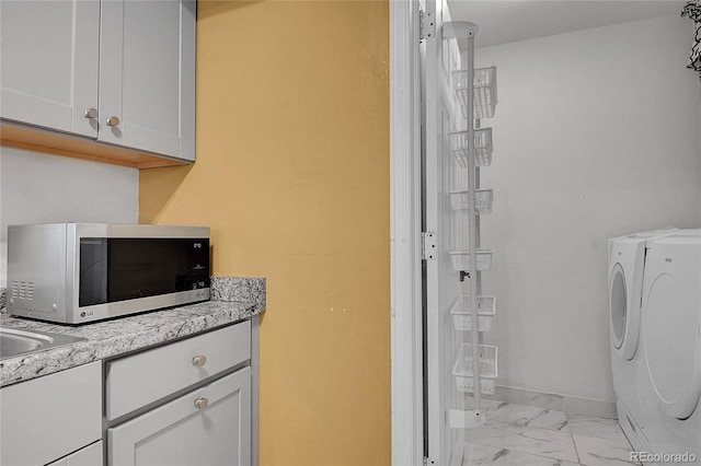 2181 S Troy Way Unit 103, Aurora, CO 80014 - laundry room with washing machine and dryer and light marble finish floors