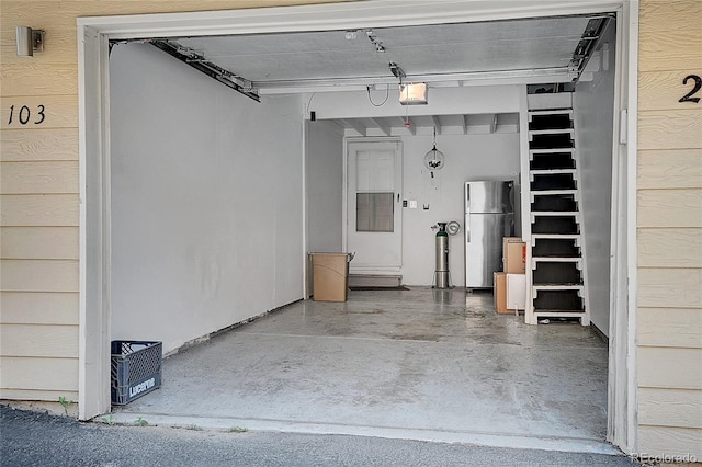 2181 S Troy Way Unit 103, Aurora, CO 80014 - garage with freestanding refrigerator and a garage door opener