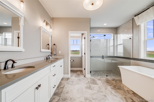 8750 Red Primrose St, Franktown, CO 80116 - bathroom featuring double vanity, a sink, a freestanding tub, and a shower stall