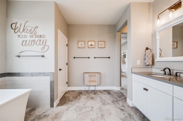 8750 Red Primrose St, Franktown, CO 80116 - full bathroom with a freestanding tub, vanity, and marble finish floor