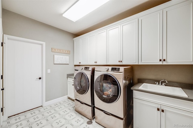 8750 Red Primrose St, Franktown, CO 80116 - laundry room with baseboards, light floors, separate washer and dryer, a sink, and cabinet space